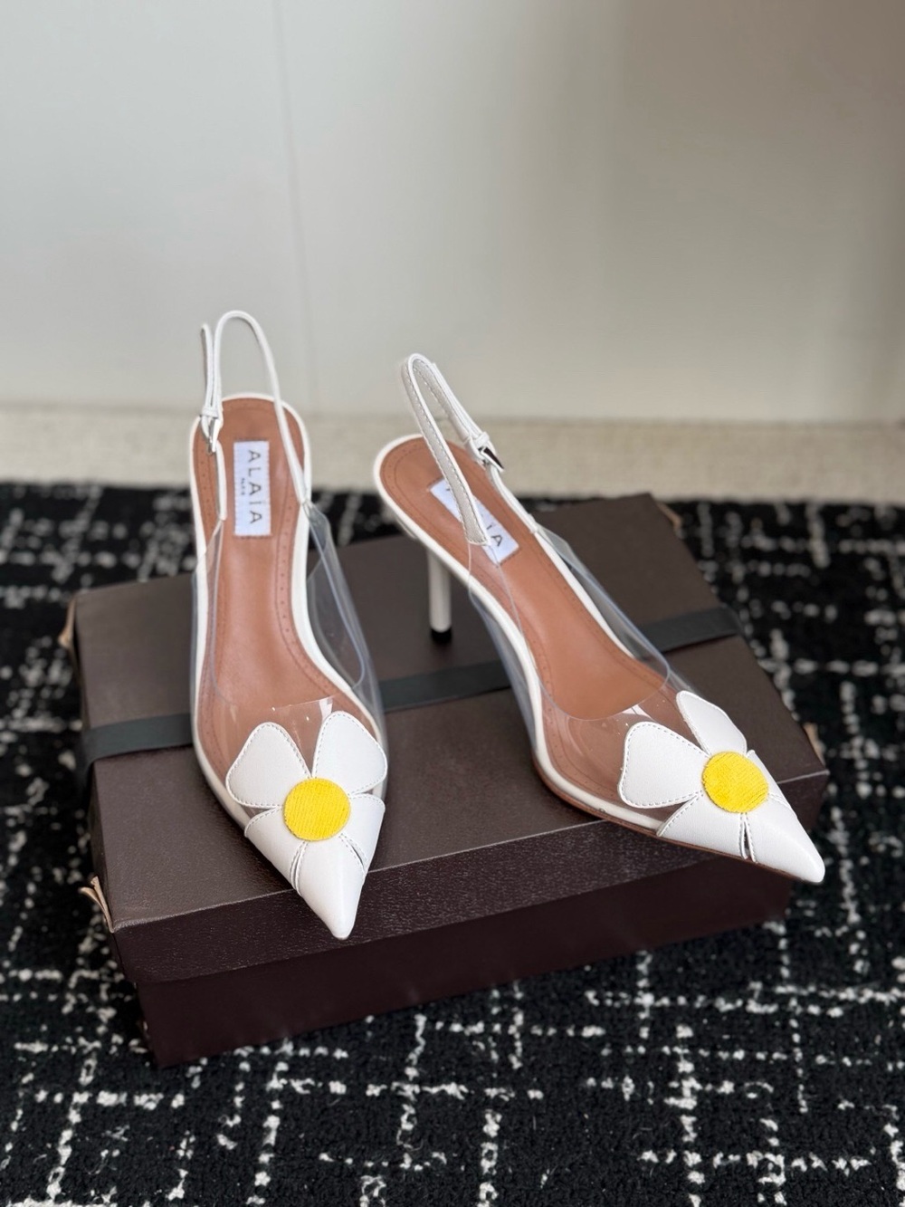 Alaia White Pointed Slingback Pumps with Yellow Daisy Accent